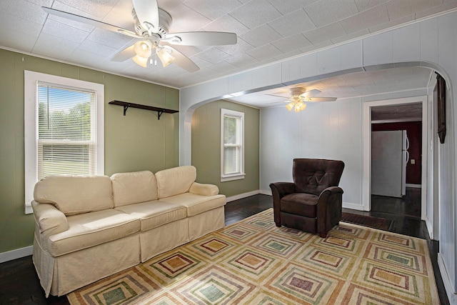 95 W N St, Ionia, MI 48846 - living area featuring ceiling fan, arched walkways, healthy amount of natural light, wood finished floors, and ornamental molding