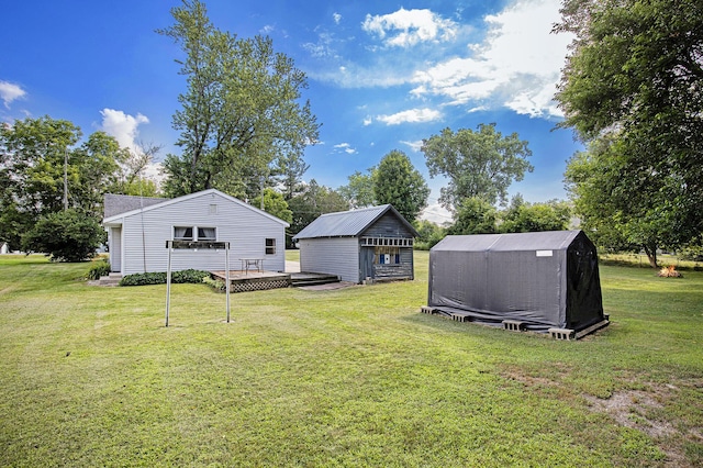 95 W N St, Ionia, MI 48846 - view of grassy yard featuring a storage unit and a wooden deck