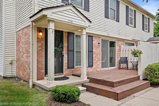 7741 Lake Ridge Dr, Commerce Twp, MI 48327 - doorway to property featuring brick siding and a wooden deck