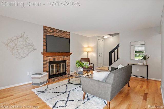 7741 Lake Ridge Dr, Commerce Twp, MI 48327 - living room with stairway, wood finished floors, and a fireplace