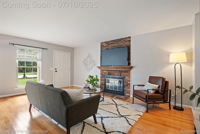 7741 Lake Ridge Dr, Commerce Twp, MI 48327 - living room with wood finished floors and a brick fireplace