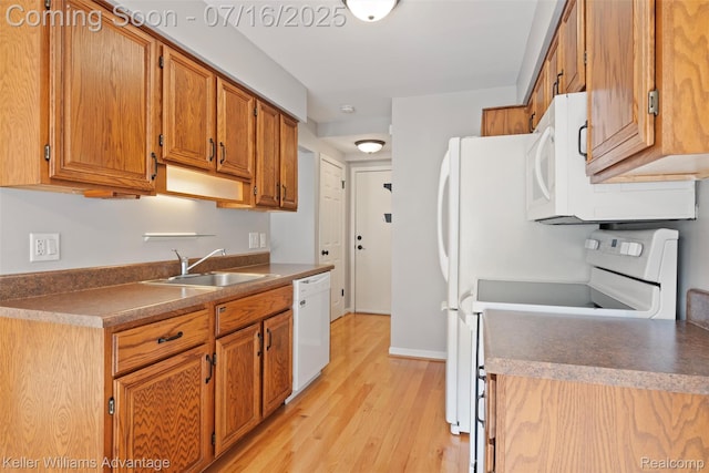 7741 Lake Ridge Dr, Commerce Twp, MI 48327 - kitchen with white appliances, light wood-style floors, brown cabinetry, and dark countertops
