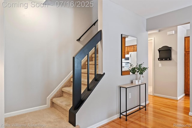7741 Lake Ridge Dr, Commerce Twp, MI 48327 - stairs featuring wood finished floors and baseboards