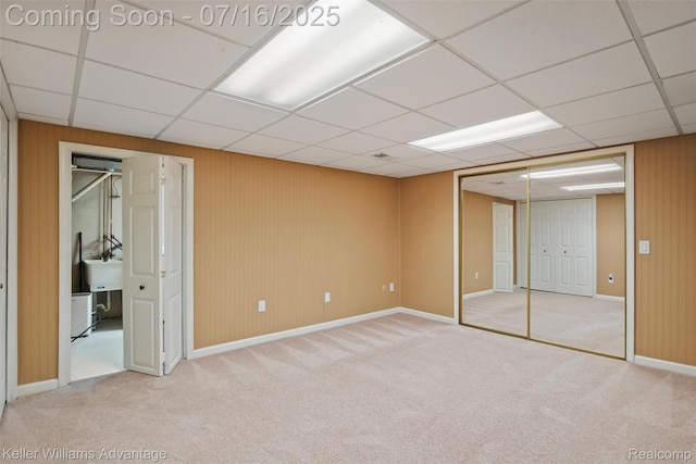 7741 Lake Ridge Dr, Commerce Twp, MI 48327 - unfurnished bedroom featuring carpet floors, a paneled ceiling, and wooden walls