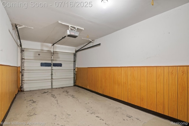7741 Lake Ridge Dr, Commerce Twp, MI 48327 - garage with a garage door opener, wood walls, and a wainscoted wall