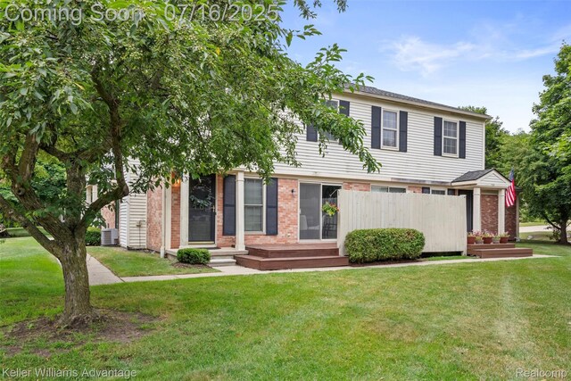 7741 Lake Ridge Dr, Commerce Twp, MI 48327 - view of front of house with a front lawn and brick siding