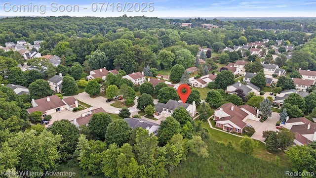 7741 Lake Ridge Dr, Commerce Twp, MI 48327 - aerial perspective of suburban area featuring a heavily wooded area