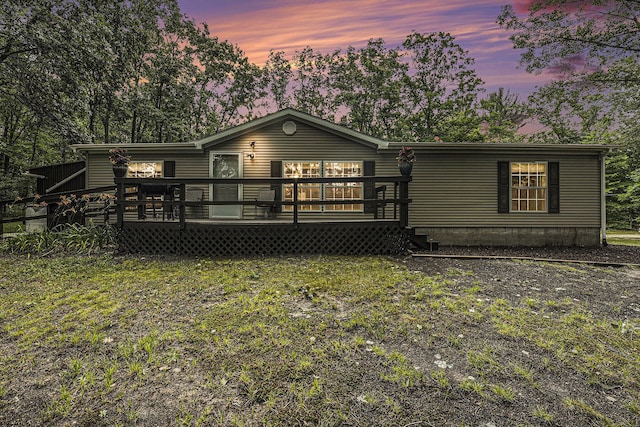 797 Beaver Rd, Bitely, MI 49309 - back of house at dusk with a wooden deck