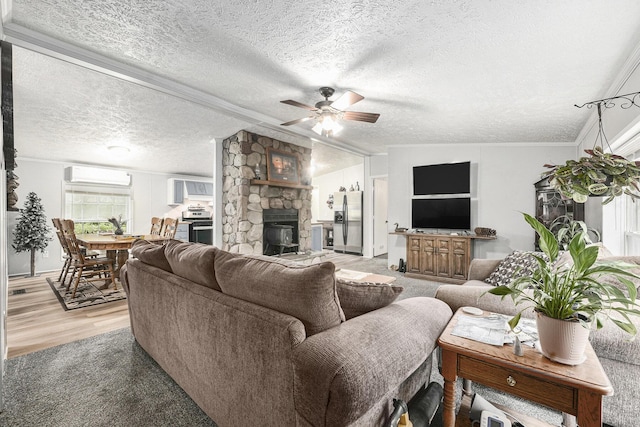 797 Beaver Rd, Bitely, MI 49309 - living area featuring a stone fireplace, ceiling fan, light wood-type flooring, and a textured ceiling
