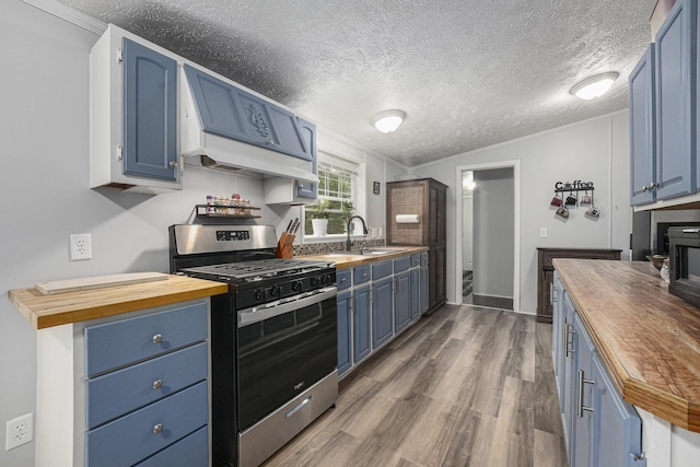 797 Beaver Rd, Bitely, MI 49309 - kitchen featuring wooden counters, blue cabinets, stainless steel gas stove, wood finished floors, and a textured ceiling