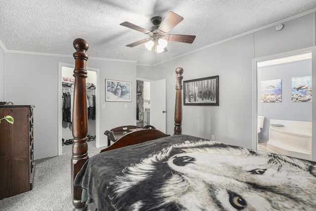 797 Beaver Rd, Bitely, MI 49309 - bedroom with carpet, a walk in closet, ornamental molding, a textured ceiling, and ensuite bath