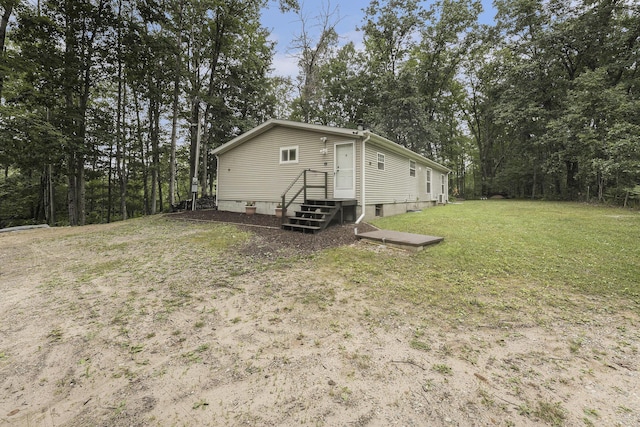 797 Beaver Rd, Bitely, MI 49309 - view of side of home featuring a yard