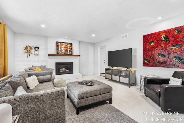 116 Loch Lomond Ave NE, Grand Rapids, MI 49546 - living area with a glass covered fireplace, light colored carpet, and recessed lighting