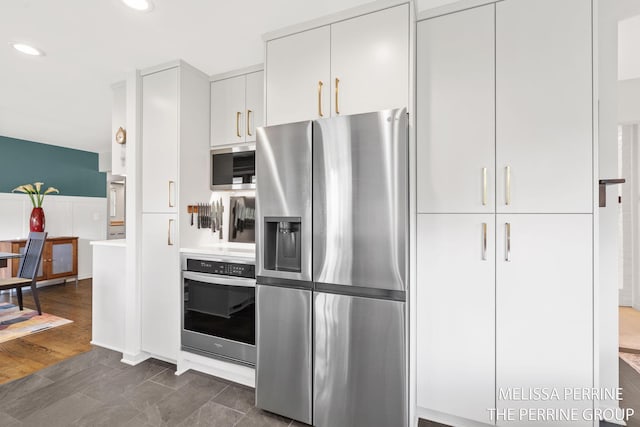 116 Loch Lomond Ave NE, Grand Rapids, MI 49546 - kitchen with stainless steel appliances, light countertops, recessed lighting, and white cabinets