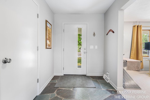 116 Loch Lomond Ave NE, Grand Rapids, MI 49546 - entrance foyer featuring stone tile flooring and baseboards