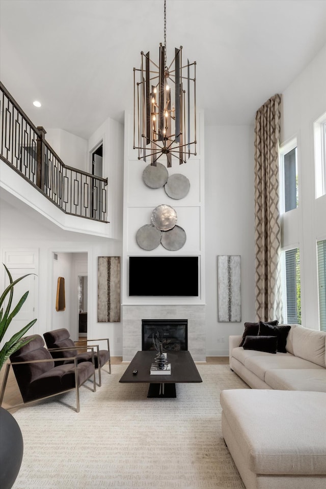 3909 Sandpiper Dr, Troy, MI 48083 - living area featuring a high ceiling, a chandelier, a glass covered fireplace, and stairway