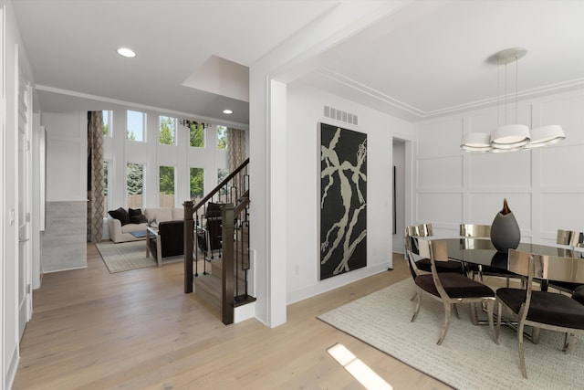 3909 Sandpiper Dr, Troy, MI 48083 - dining area featuring stairs, a decorative wall, light wood finished floors, a chandelier, and recessed lighting