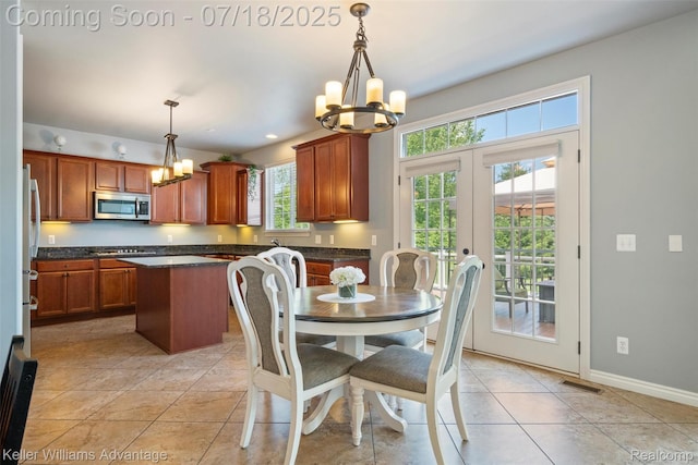 25506 Stanley Ln, South Lyon, MI 48178 - dining space with a chandelier, french doors, and light tile patterned flooring