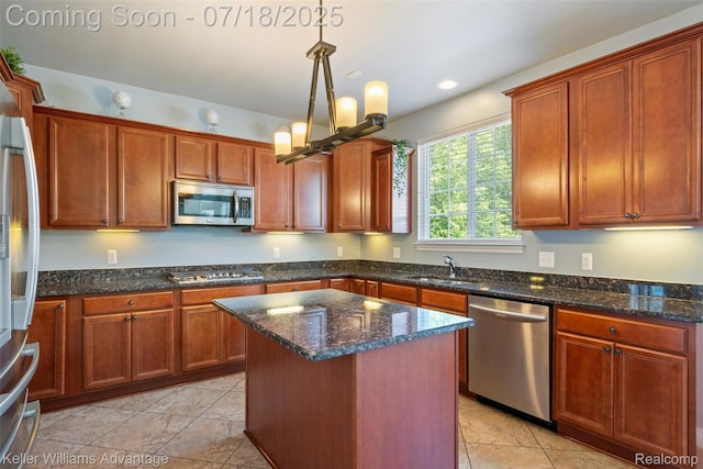 25506 Stanley Ln, South Lyon, MI 48178 - kitchen featuring stainless steel appliances, dark stone countertops, a center island, pendant lighting, and recessed lighting