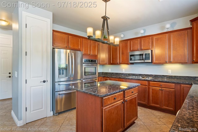 25506 Stanley Ln, South Lyon, MI 48178 - kitchen featuring appliances with stainless steel finishes, a center island, dark stone countertops, hanging light fixtures, and light tile patterned floors