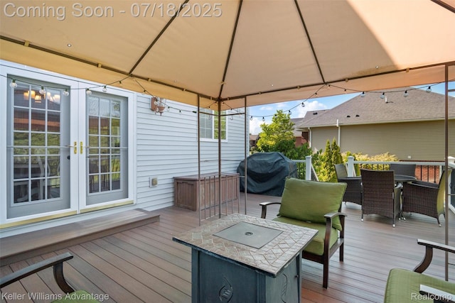 25506 Stanley Ln, South Lyon, MI 48178 - deck featuring area for grilling, outdoor dining space, french doors, and a gazebo