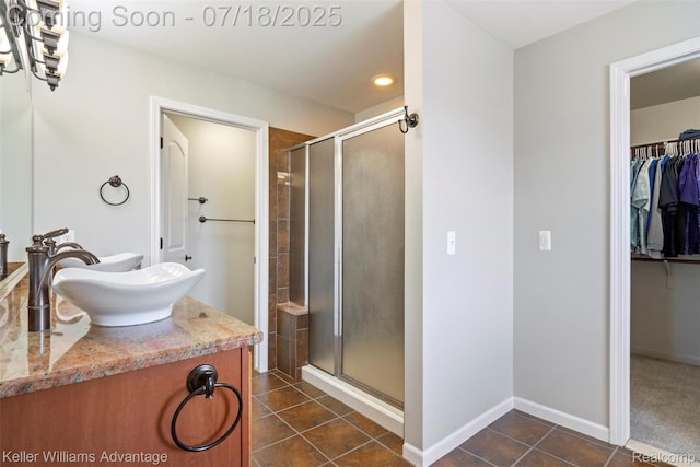 25506 Stanley Ln, South Lyon, MI 48178 - full bathroom featuring tile patterned flooring, a shower stall, a spacious closet, vanity, and recessed lighting