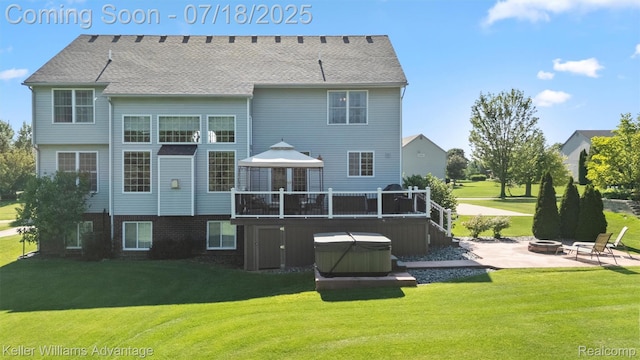 25506 Stanley Ln, South Lyon, MI 48178 - rear view of property featuring an outdoor fire pit, a hot tub, a patio area, and a yard