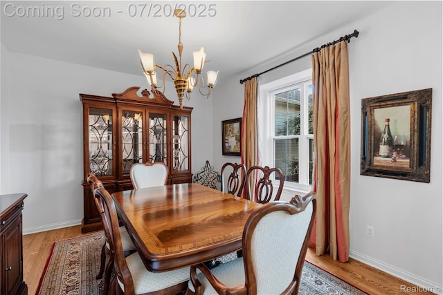 9589 Wellington Ct, Clarkston, MI 48348 - dining room featuring a chandelier and light wood-style floors