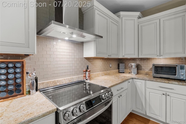 9589 Wellington Ct, Clarkston, MI 48348 - kitchen featuring electric stove, wall chimney range hood, tasteful backsplash, white cabinetry, and light stone counters