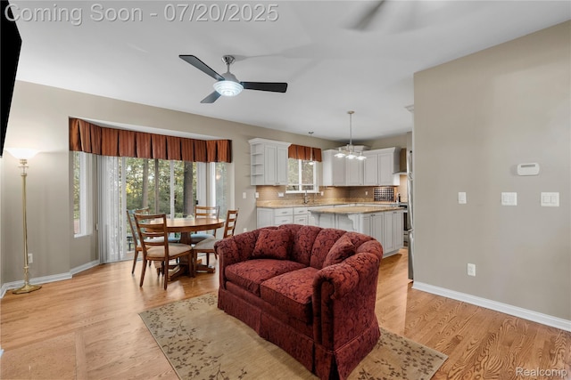 9589 Wellington Ct, Clarkston, MI 48348 - living room with a ceiling fan and light wood-style floors