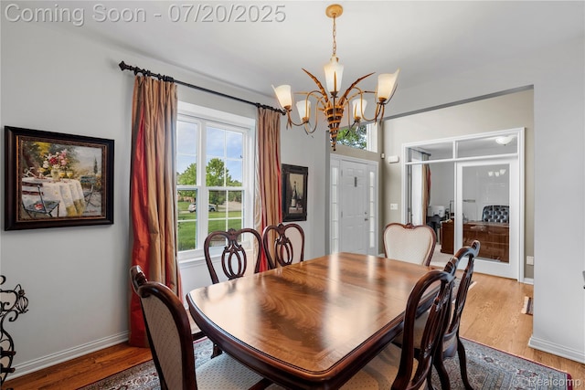 9589 Wellington Ct, Clarkston, MI 48348 - dining room with a chandelier and light wood-style flooring