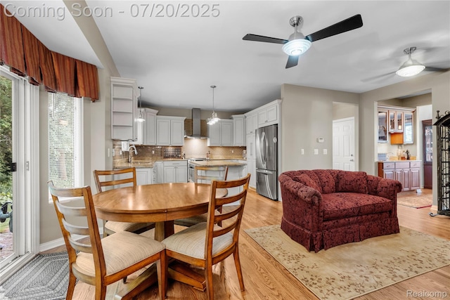 9589 Wellington Ct, Clarkston, MI 48348 - dining area with a ceiling fan and light wood-style flooring