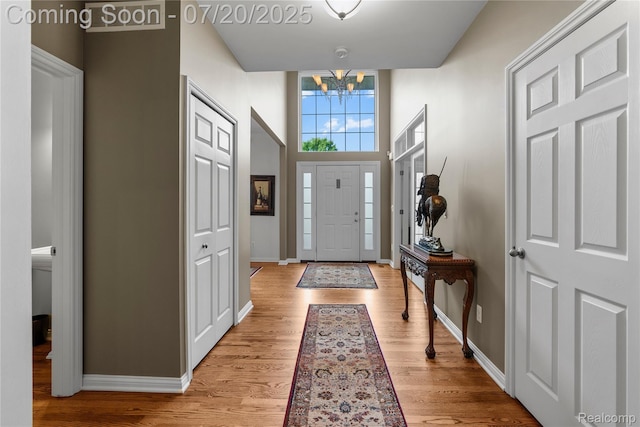 9589 Wellington Ct, Clarkston, MI 48348 - entrance foyer featuring a chandelier and light wood-style flooring