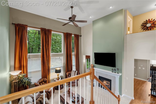 9589 Wellington Ct, Clarkston, MI 48348 - living room with ceiling fan, a glass covered fireplace, recessed lighting, and wood finished floors