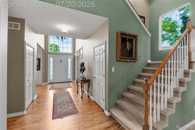 9589 Wellington Ct, Clarkston, MI 48348 - foyer entrance featuring light wood-style floors and stairway