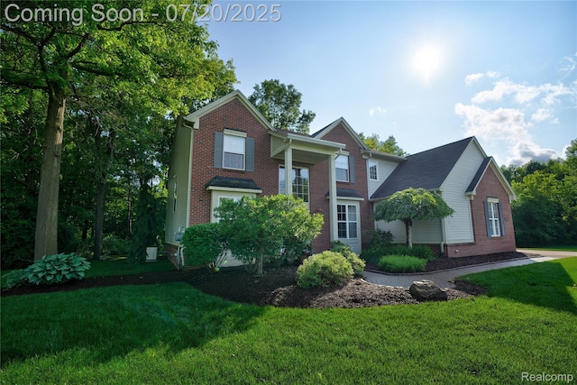 9589 Wellington Ct, Clarkston, MI 48348 - view of front of property with brick siding and a front yard