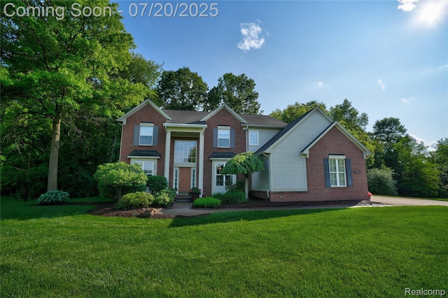 9589 Wellington Ct, Clarkston, MI 48348 - view of front facade featuring brick siding and a front lawn