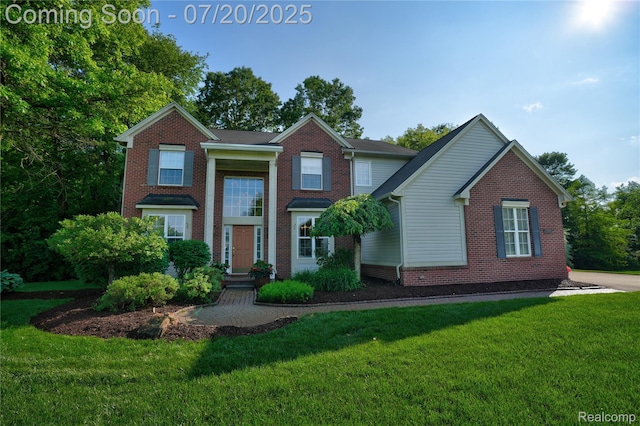 9589 Wellington Ct, Clarkston, MI 48348 - view of front facade with a front lawn and brick siding