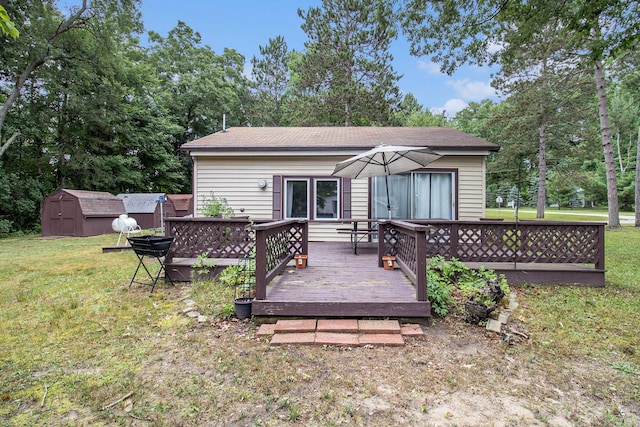 435 Pettibone Dr, Bitely, MI 49309 - rear view of property featuring a storage shed, a yard, a deck, and view of scattered trees