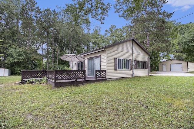 435 Pettibone Dr, Bitely, MI 49309 - back of house featuring an outbuilding, a detached garage, a lawn, and a wooden deck