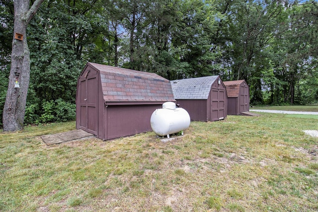 435 Pettibone Dr, Bitely, MI 49309 - view of grassy yard featuring a storage shed and view of wooded area