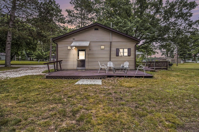 435 Pettibone Dr, Bitely, MI 49309 - back of house with a wooden deck and a lawn