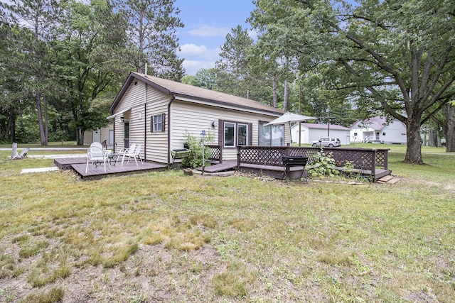 435 Pettibone Dr, Bitely, MI 49309 - rear view of property with a wooden deck and a lawn