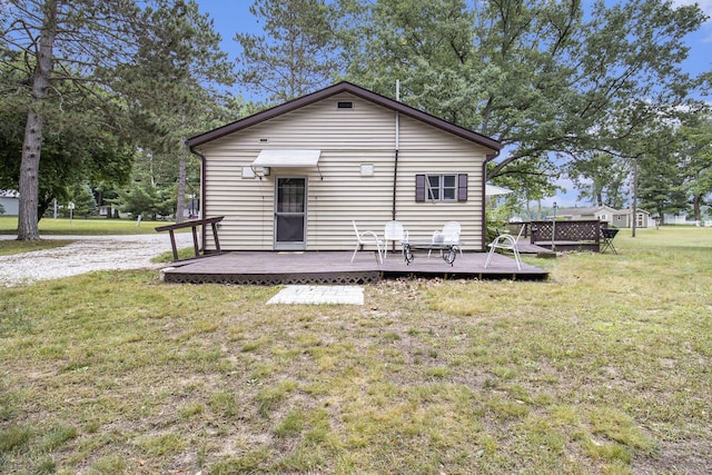 435 Pettibone Dr, Bitely, MI 49309 - rear view of property featuring a lawn and a wooden deck