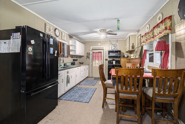 435 Pettibone Dr, Bitely, MI 49309 - kitchen with black appliances, ceiling fan, white cabinetry, light colored carpet, and open shelves