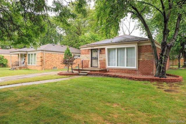 24270 Scotia Rd, Oak Park, MI 48237 - view of front of home featuring brick siding, a front yard, and concrete driveway