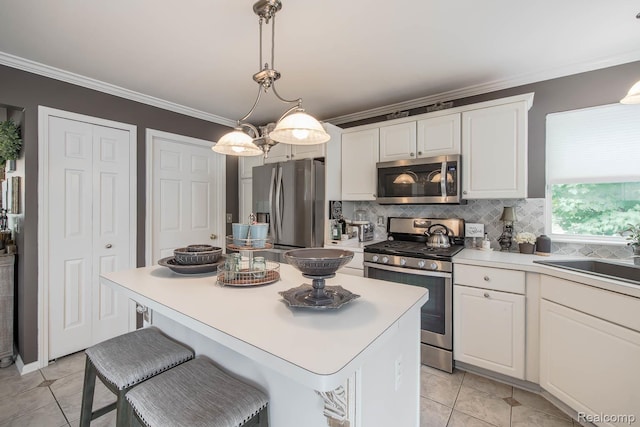 4500 Red Oak Blvd, Waterford, MI 48329 - kitchen featuring appliances with stainless steel finishes, ornamental molding, white cabinets, decorative backsplash, and a kitchen island