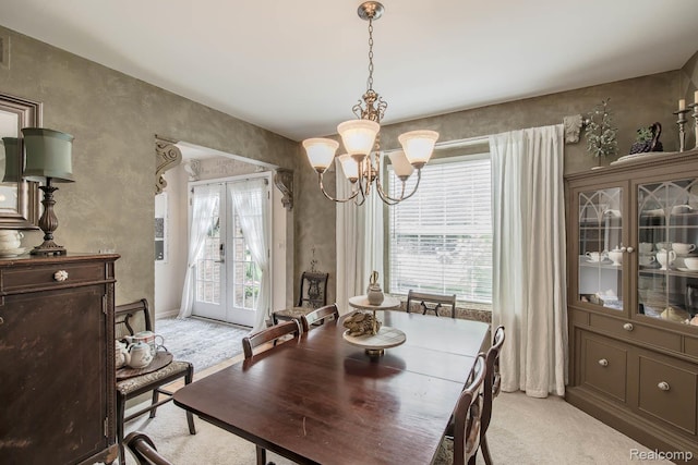 4500 Red Oak Blvd, Waterford, MI 48329 - dining space featuring a chandelier, light carpet, and french doors