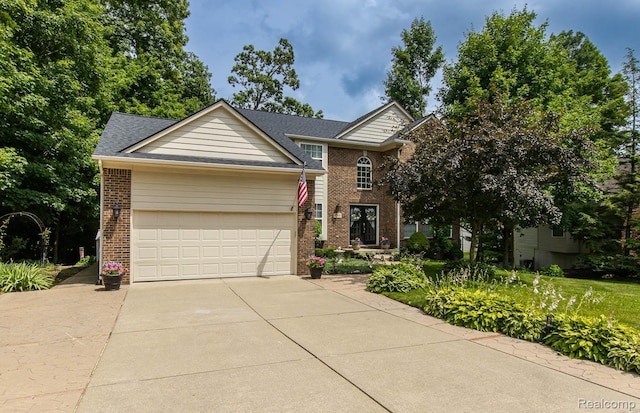 4500 Red Oak Blvd, Waterford, MI 48329 - traditional-style home with brick siding, an attached garage, and concrete driveway