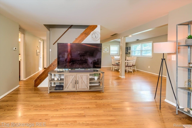 166 Indian Trl, Columbiaville, MI 48421 - living area with light wood finished floors and lofted ceiling